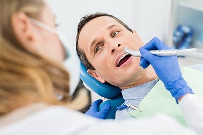 restorative dentist working with patient